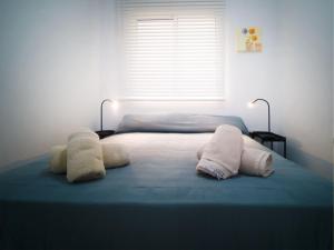 a bedroom with a bed with two pillows on it at Banana Beach in Marbella