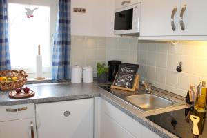 a kitchen with a sink and a counter top at Landhaus Lippmann Whg6 in Grönwohldshorst