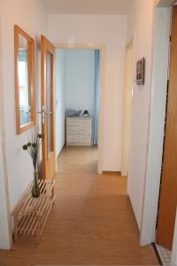 a hallway with a room with a dresser at Landhaus Lippmann Whg6 in Grönwohldshorst