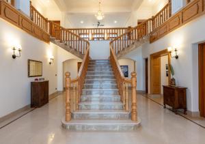 a spiral staircase in a home with white walls at Lohono Stays Villa Noor in Srinagar