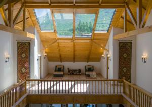a large room with a large ceiling with windows at Lohono Stays Villa Noor in Srinagar +24 photos