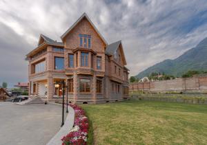 a large brick house with a large yard at Lohono Stays Villa Noor in Srinagar