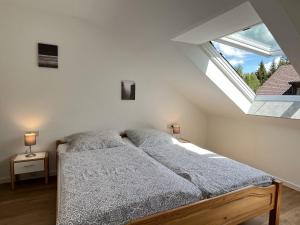 a bedroom with a bed and a large window at Apartment Heidelberg by Interhome in Hinterzarten