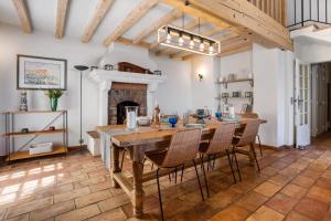 a dining room with a table and chairs and a fireplace at Villa La Louisière - Les Issambres in Saint-Peïre-sur-Mer