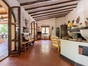 a kitchen and living room with wooden ceilings at Villa La Casetta del Mare by Interhome in Villasimius