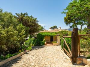a garden with a gate and a house at Villa La Casetta del Mare by Interhome in Villasimius