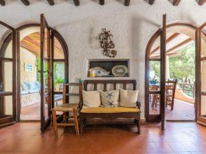 a living room with a chair and a table at Villa La Casetta del Mare by Interhome in Villasimius