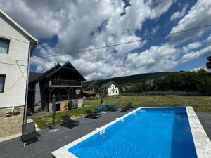 a swimming pool in the yard of a house at GARAGE in Yaremche
