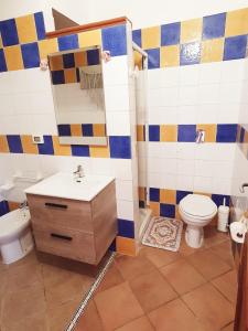 a bathroom with a sink and a toilet at Villa Migliore in Lampedusa