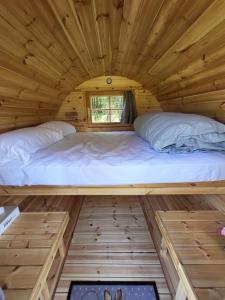 a bed in a tiny house at Les cabanes du veau in Daumeray +12 photos