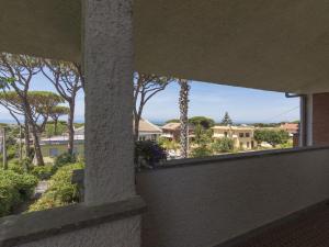 a view from the balcony of a house with trees at Apartment Gli Oleandri by Interhome in Casale Vignarola