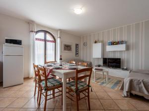 a kitchen and living room with a table and chairs at Holiday Home Collina San Ponzio by Interhome in Barolo