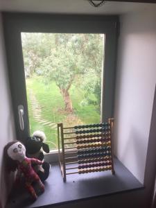two stuffed animals are sitting on a window sill at La Poitevinière in Sainte-Hermine +12 photos
