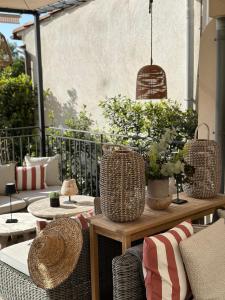 a patio with rattan chairs and a table with plants at La R&eacute;serve by Mougins Luxury Retreats in Mougins