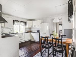 a kitchen and dining room with a table and chairs at Chalet Motorp by Interhome in Arboga