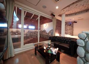 a living room with a couch and a large window at hotel SWEET SEASON in Hashima +7 photos