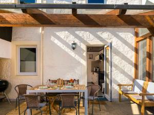 a patio with a table and chairs and a building at Holiday Home Bruni by Interhome in Manderscheid