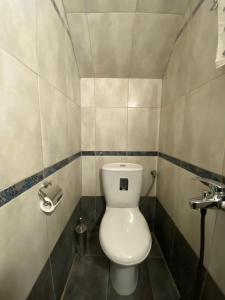 a bathroom with a white toilet in a room at Golden House in Chrysoupolis +12 photos