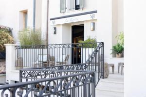 a balcony with a black iron railing in front of a building at La R&eacute;serve by Mougins Luxury Retreats in Mougins