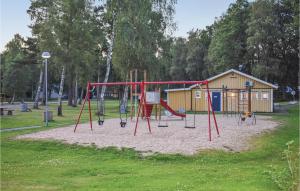 a playground with a swing set in a park at Gorgeous Home In Hästveda With Kitchen in Hästveda