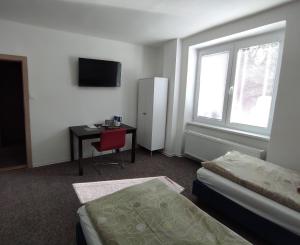 Habitación con cama, escritorio y ventana. en Hostel 26, en Košice