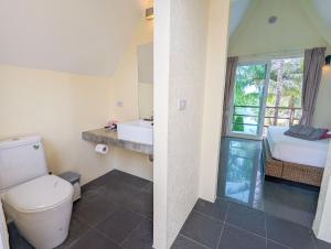 a bathroom with a toilet and a sink and a bed at Villa with Private Pool - by KohChangVillas in Ko Chang +18 photos