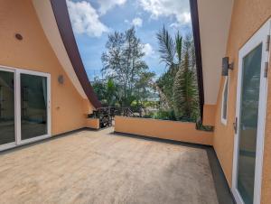 a large balcony with a view of the ocean at Villa with Private Pool - by KohChangVillas in Ko Chang