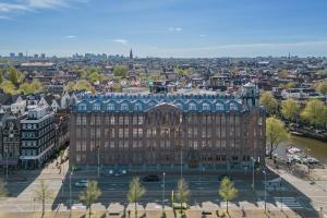 an aerial view of a large building in a city at Grand Hotel Amrâth Amsterdam in Amsterdam