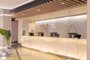 a lobby with a reception desk in a building at Melia Alicante in Alicante