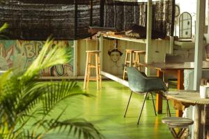 a room with tables and chairs and a painting on the wall at Ringo's Foyer in Melaka