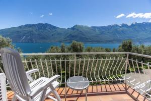 a balcony with chairs and a view of a lake at Hotel Villa Margherita in Limone sul Garda