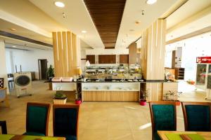 a restaurant with a kitchen with a counter and chairs at Shellghada Blue Beach in Hurghada