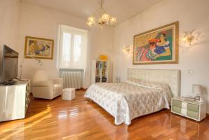 a bedroom with a bed and a painting on the wall at Palazzo Podestà in Civitavecchia +126 photos
