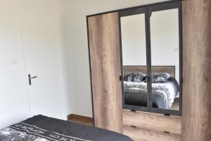 a bedroom with a mirror with a bed in it at Maisons Phoenix in Saint-Jean-de-Monts +52 photos