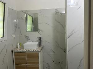 a white bathroom with a sink and a mirror at B&B Ravenna in Ravenna