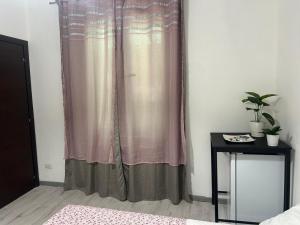 a curtain in a room with a table and a bed at B&B Ravenna in Ravenna