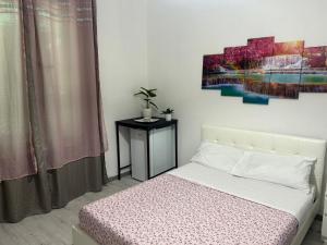 a bedroom with a bed and a painting on the wall at B&B Ravenna in Ravenna