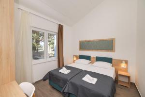 Postel nebo postele na pokoji v ubytování Apartments Medena