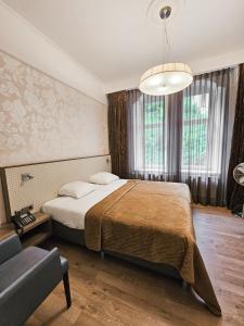 Postel nebo postele na pokoji v ubytování Parkhotel Valkenburg
