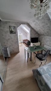 a living room with a table and a desk at Guest House Krista in Jūrmala