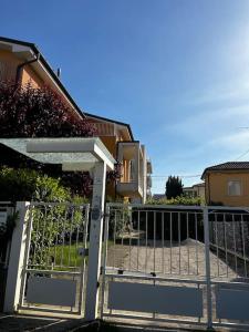an open gate in front of a house at Giada Family House in Senigallia