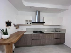 a kitchen with a sink and a wooden counter top at Giada Family House in Senigallia