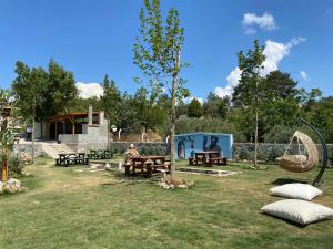 a park with picnic tables and a swing at Nu-se Garden Butik Otel in Selcuk