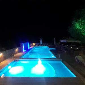 a large swimming pool at night with lights at Nu-se Garden Butik Otel in Selcuk