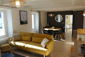 a living room with a couch and a dining room at Paimpol centre 500m du port in Paimpol