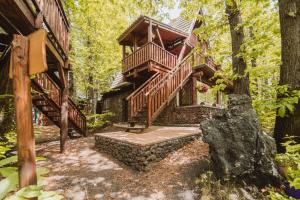 a tree house in the woods with a staircase at Matilde's Chalet Etna Nature House in Nicolosi