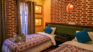 Letto o letti in una camera di Hong Si Hotel- A Home Away from Home