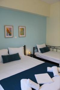 a room with two beds with a laptop on it at AnaLev Apartment in Nea Peramos