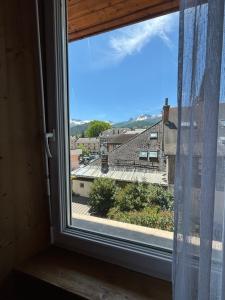 a window with a view of a roof at Chez LIZON in Barcelonnette