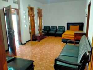 a living room with leather chairs and a couch at CELLINO HOMESTAy 2 in Probolinggo